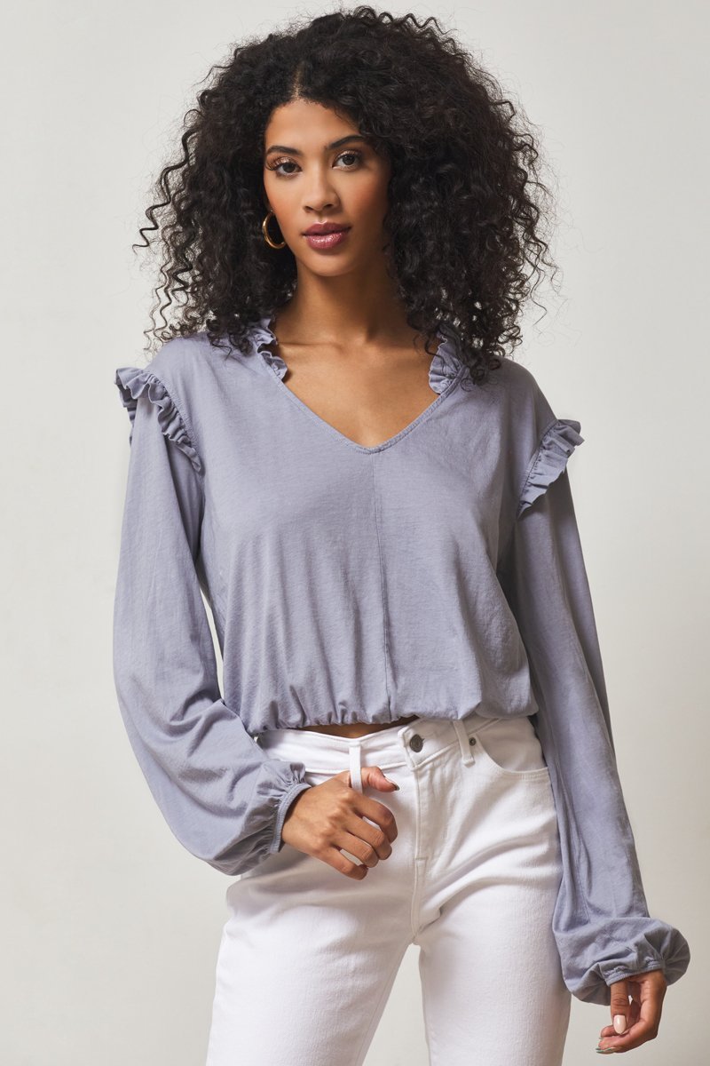 light blue top with ruffles on shoulder