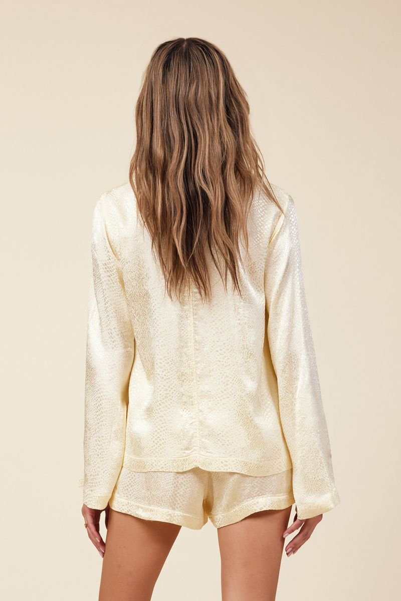 back of long sleeve cardigan and short in light yellow jacquard snakeprint