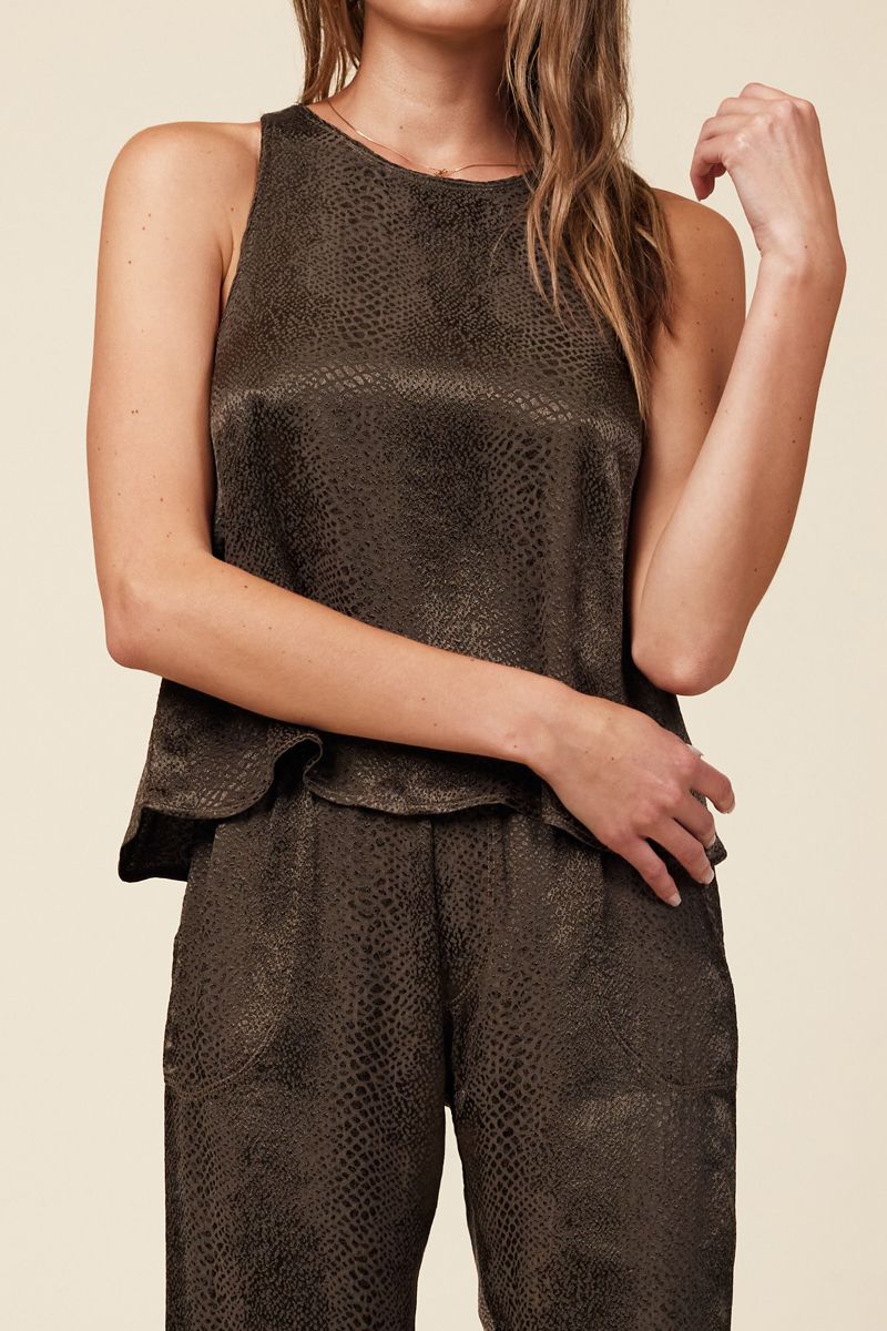 close up of dark green swing top with a snake print jacquard