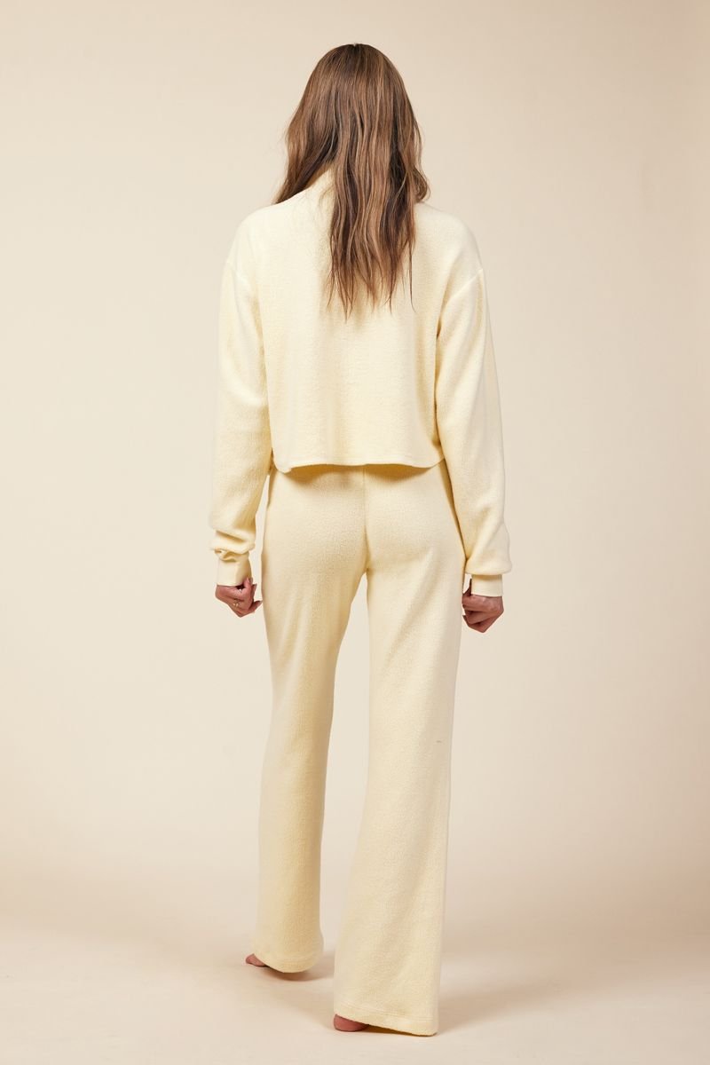back of light yellow sherpa set in wide leg pant and sweatshirt