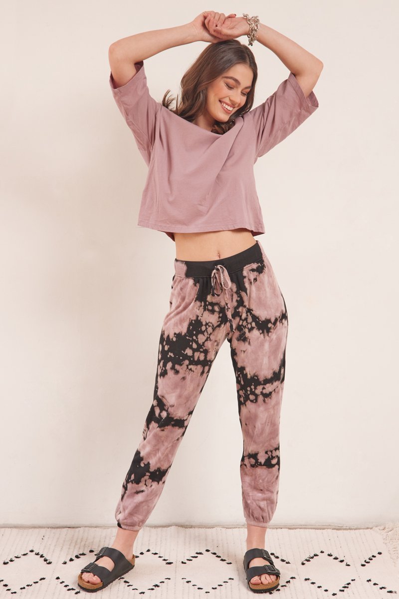 model standing in casual cotton tee and black and pink sweatpants