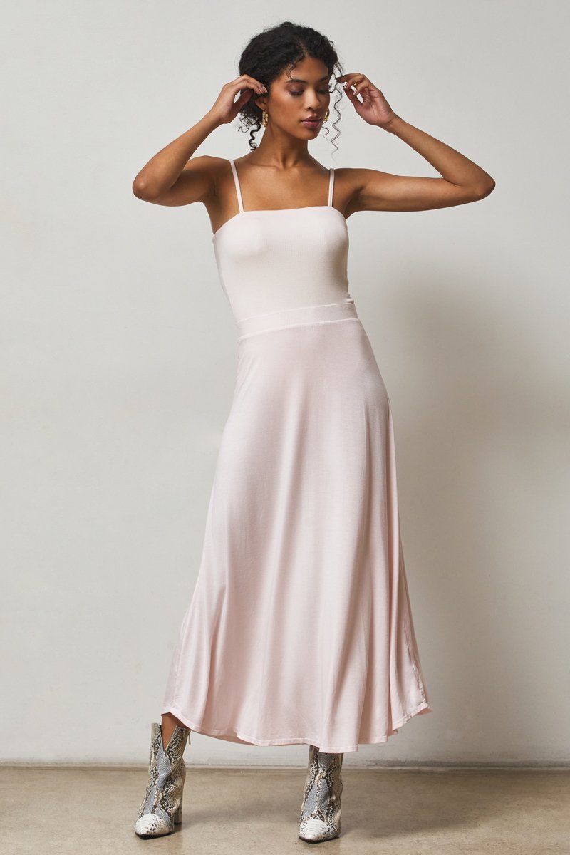 feminine outfit of a blush colored pink bodysuit and flowy blush maxi skirt
